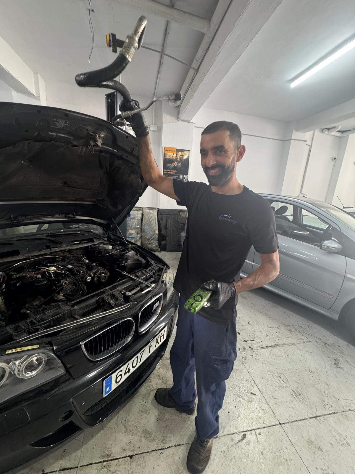 Mechanic working on a vehicle in a clean workshop