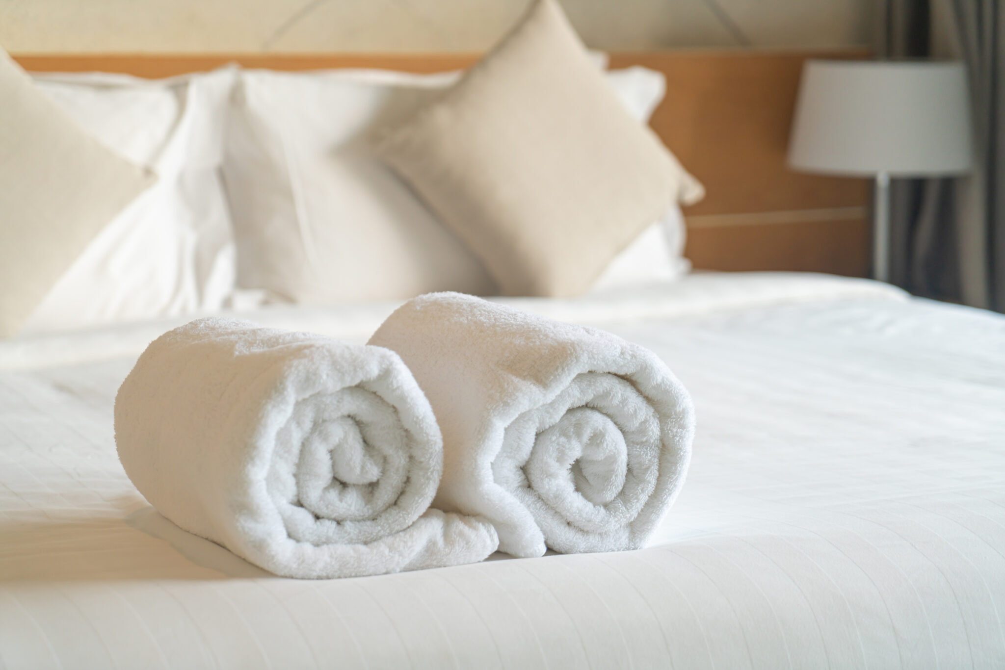 close-up white towel on bed in bedroom